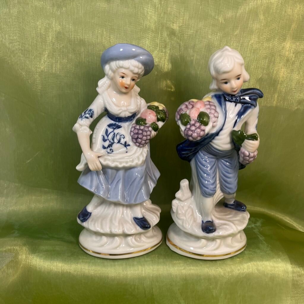 Victorian/colonial figurines harvesting grapes