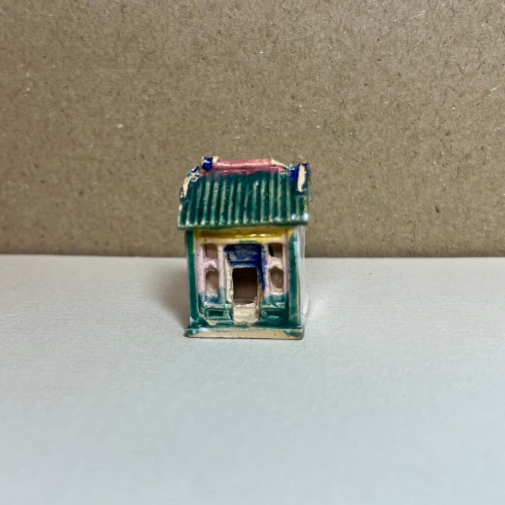 Tiny hand-painted ceramic house figurine
