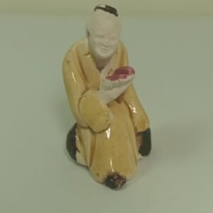 Small ceramic kneeling figurine