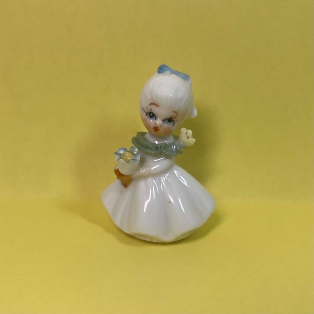 Napco-Style 2" Bone China girl with blue bow and yellow flowers